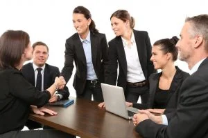 Business team shaking hands at a meeting table