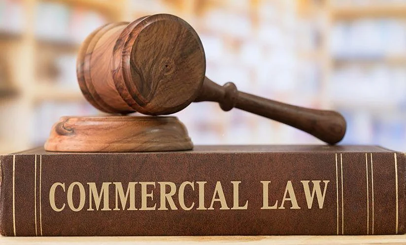Gavel resting on a book titled Commercial Law