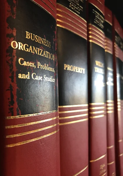 Law book spines, including Business Organizations: Cases, Problems, and Case Studies