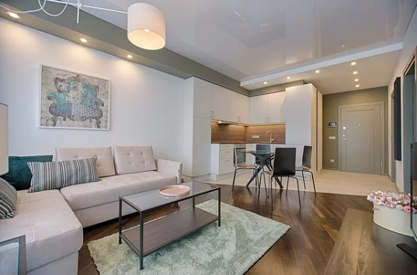 Furnished apartment living room with a sofa, coffee table and open kitchen